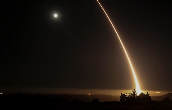 A streak of light trails off into the night sky as the US military test fires an unarmed ICBM at Vandenberg Air Force Base in 2017. (Photo by Ringo Chiu/AFP via Getty Images)