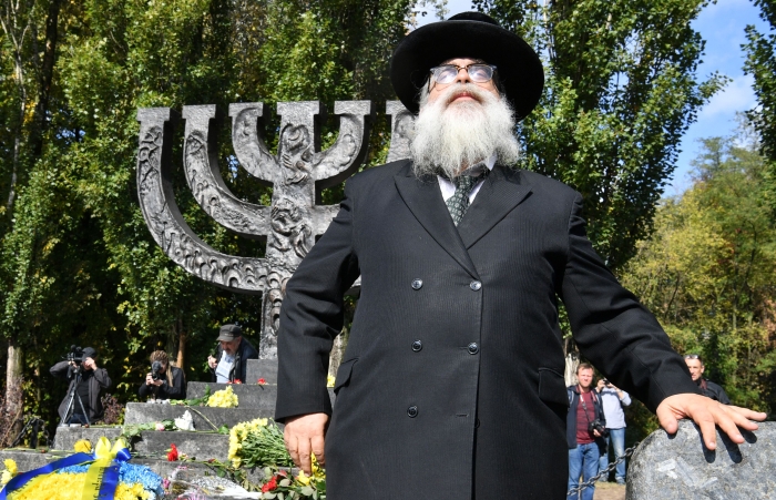 A rabbi prays in front of the Minorah Monument at the Babyn Yar (Babi Yar) Holocaust Memorial in Kiev, on September 29, 2019, during a mourning ceremony marking the 78th anniversary of the beginning of mass execution of Jews in September 1941. - The Babi Yar (Babyn Yar) ravine in Kiev, was the location where Nazis shot dead several tens of thousands of Jews between 1941-1944. (Photo by SERGEI SUPINSKY/AFP via Getty Images)