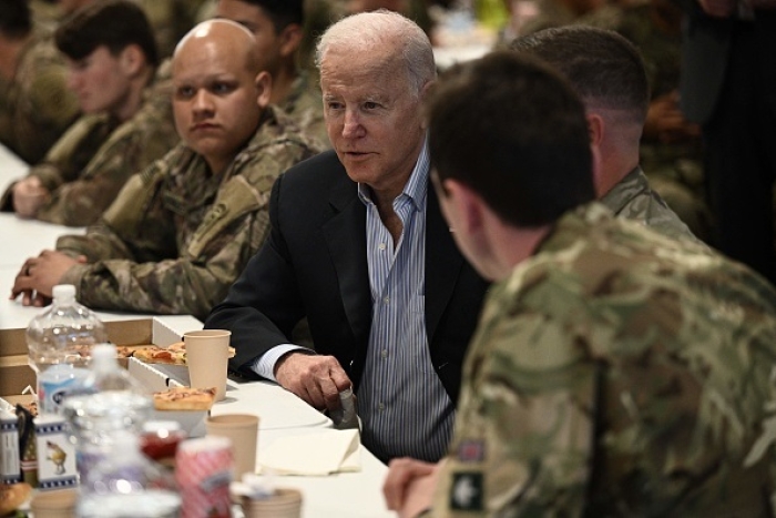 President Joe Biden talks to service members from the 82nd Airborne Division in Poland on March 25, 2022. (Photo by BRENDAN SMIALOWSKI/AFP via Getty Images)