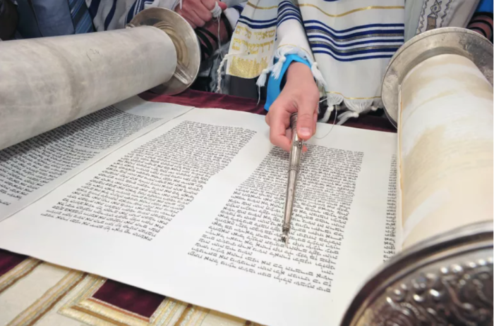 A young man reads from the Torah at the wailing wall in Israel.  (Getty Images)