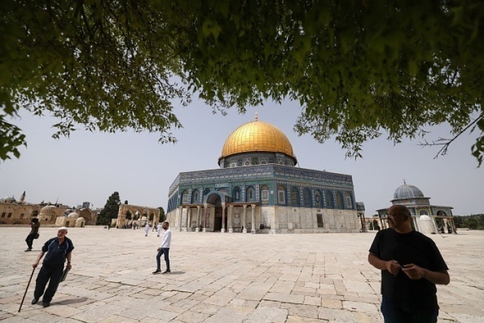 Palestinians walk on Sunday near the Dome of Rock mosque on the Old City of Jerusalem hilltop that is also the location of the al-Aqsa mosque, Islam’s third holiest. The Temple Mount is the holiest site in Judaism. (Photo by Ahmad Gharabli/AFP via Getty Images)