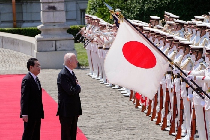 President Biden and Japanese Prime Minister Fumio Kishida review an honour guard during a welcome ceremony in Tokyo on Monday morning. (Photo by Eugene Hoshiko / Pool /AFP via Getty Images)