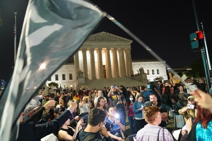 Protestors gathered outside the U.S. Supreme Court on Monday night after publication of a leaked draft of a majority opinion indicating that the court is poised to overturn Roe v. Wade. (Photo by Stefani Reynolds / AFP via Getty Images)