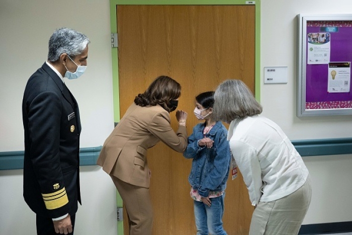 Vice President Kamala Harris greets a young patient while touring Children's National Hospital in Washington, DC, on May 23, 2022. (Photo by BRENDAN SMIALOWSKI/AFP via Getty Images)