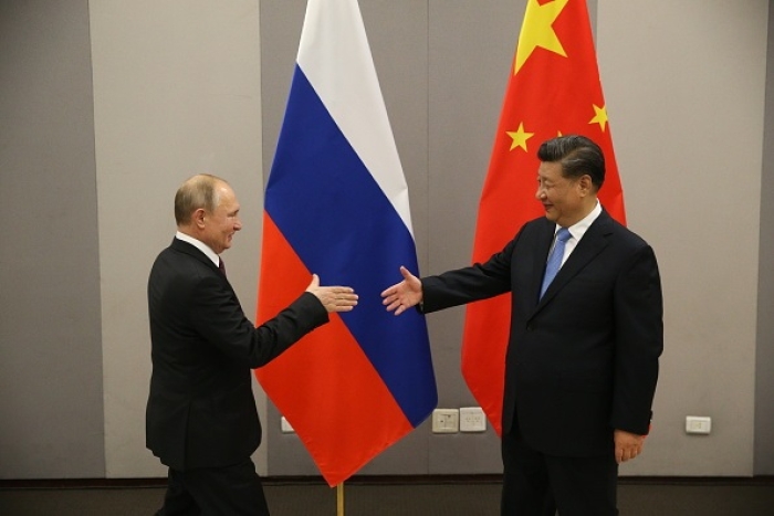 Russian President Vladimir Putin greets Chinese President Xi Jinping during their bilateral meeting on November 13, 2019 in Brasilia, Brazil. (Photo by Mikhail Svetlov/Getty Images)