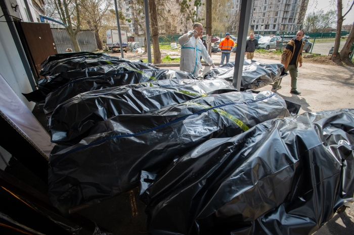 Ukrainian morticians look at body bags full of corpses, as a morgue overflows with victims who died during the Russian military presence in the Kyiv suburb of Bucha, Ukraine, on April 23, 2022. (Getty Images)
