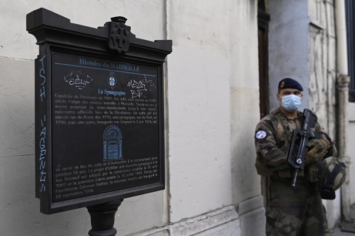 During an anti-terror operation, a French soldier stands guard at a synogogue in Marseilles. (Photo by Christophe Simon/AFP via Getty Images)
