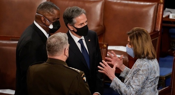 House Speaker Nancy Pelosi talks with chairman of the Joint Chiefs of Staff Gen. Mark Milley, Defense Secretary Gen. Lloyd Austin, and Secretary of State Antony Blinken at the U.S. Capitol in April 2021. (Photo by Andrew Harnik / Pool / AFP via Getty Images)