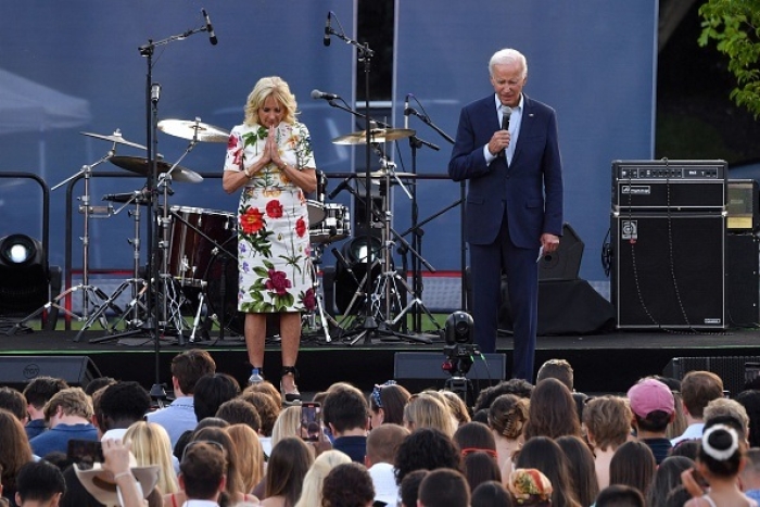 President Joe Biden andFirst Lady Jill Biden bow their heads during a moment of silence for the victims of the Highland Park shooting on July 4. (Photo by NICHOLAS KAMM/AFP via Getty Images)
