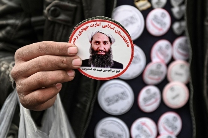 A man sells stickers in Kabul last December featuring images of the Taliban’s reclusive supreme leader Hibatullah Akhundzada. One day after the last U.S. troops left Afghanistan last August, al-Qaeda renewed its allegiance to Akhundzada as “leader of the faithful.” (Photo by Mohd Rasfan/AFP via Getty Images)