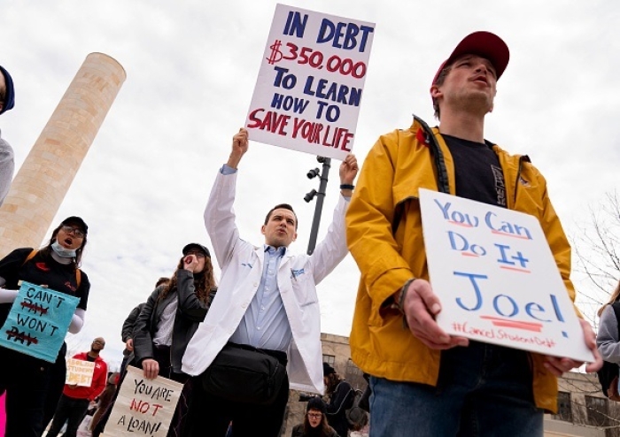Student debtors rally outside the Education Department in Washington on April 4, 2022. (Photo by STEFANI REYNOLDS/AFP via Getty Images)