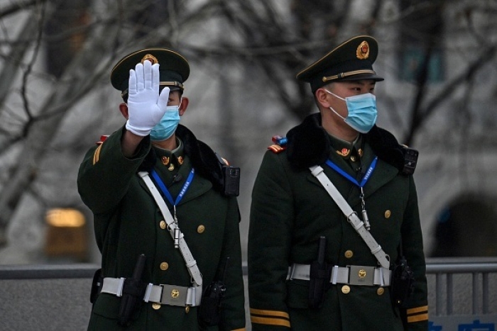 Chinese paramilitary police in Shanghai on February 14, 2022. (Photo by HECTOR RETAMAL/AFP via Getty Images)