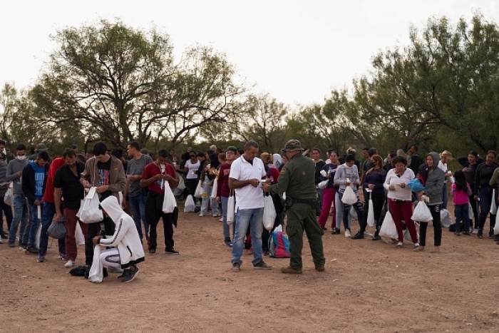 Migrants are processed by US Border Patrol after they illegally crossed the US southern border with Mexico on October 9, 2022 in Eagle Pass, Texas. In the 2022 fiscal year US Customs and Border Patrol has encountered over 2 million illegal border-crossers, setting a new record in CBP history. (Photo by ALLISON DINNER/AFP via Getty Images)