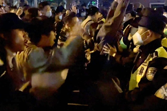A screengrab from eyewitness video footage shows protestors in Shanghai confronting police at the weekend. (Photo by AFPTV / AFP via Getty Images) A screengrab from eyewitness video footage shows protestors in Shanghai confronting police at the weekend. (Photo by AFPTV / AFP via Getty Images)