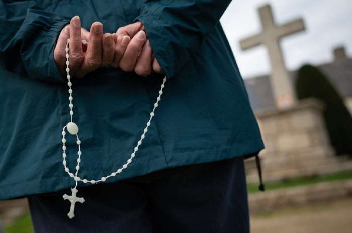 A Catholic visits a cross and statue of the Virgin Mary in western France. (Photo by Loic Venance / AFP via Getty Images) A Catholic visits a cross and statue of the Virgin Mary in western France. (Photo by Loic Venance / AFP via Getty Images)