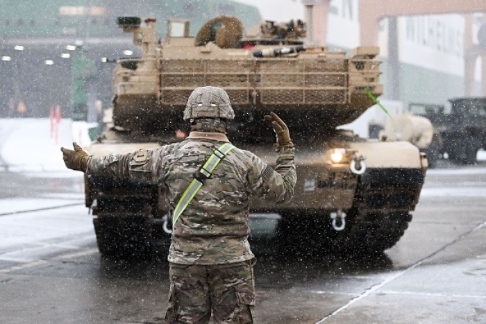 A U.S. Army soldier directs an M1A2 Abrams battle tank upon its arrival in Poland for training exercises in December 2022. (Photo by MATEUSZ SLODKOWSKI/AFP via Getty Images) A U.S. Army soldier directs an M1A2 Abrams battle tank upon its arrival in Poland for training exercises in December 2022. (Photo by MATEUSZ SLODKOWSKI/AFP via Getty Images)