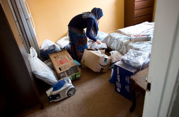 Refugees from Afghanistan move into their apartment in the Queens borough of New York City. (Photo by Andrew Lichtenstein/Corbis via Getty Images) Refugees from Afghanistan move into their apartment in the Queens borough of New York City. (Photo by Andrew Lichtenstein/Corbis via Getty Images)