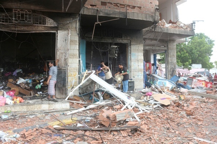 The aftermath of a car bomb attack near the airport of the southern Yemeni city of Aden, on October 31, 2021. At least 12 civilians, including children, were killed, security officials said. (Photo by SALEH AL-OBEIDI/AFP via Getty Images)