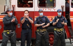 Members of the New York City Fire Department applaud frontline medical staff and essential workers at NYU Langone Health in NYC. (Photo by Noam Galai/Getty Images)