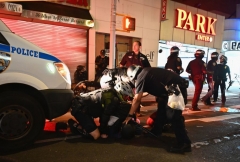 People are arrested after looting on June 2, 2020 in New York City. - Anti-racism protests have put several US cities under curfew to suppress rioting, following the death of George Floyd while in police custody. (Photo by ANGELA WEISS/AFP via Getty Images)