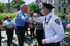 New York Mayor Bill de Blasio greets Inspector Isa Abbassi of the 120th Precinct as New York City's second Black Lives Matter mural is painted by volunteers between Borough Hall and the 120th Precinct in the Borough of Staten Island on June 19, 2020, as the city marks Juneteenth. (Photo by BRYAN R. SMITH/AFP via Getty Images)