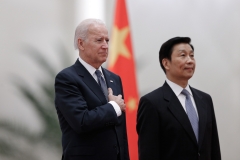 Chinese Vice President Li Yuanchao (R) and U.S. Vice President Joe Biden (L) listen to their national anthems during a welcoming ceremony inside the Great Hall of the People in Beijing on December 4, 2013. (Photo credit: LINTAO ZHANG/AFP via Getty Images)