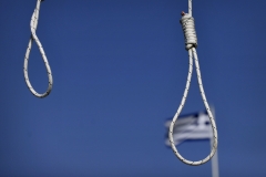 Nooses are featured outside Greece's parliament building. (Photo credit: LOUISA GOULIAMAKI/AFP via Getty Images)