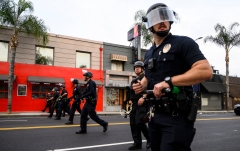 Police officers stand at the ready. (Photo credit: ROBYN BECK/AFP via Getty Images)