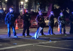 Security officials form a line across a street in Portland, Oregon early July 26, 2020, as protests continue across the United States following the death in Minneapolis of unarmed African-American George Floyd. (Photo by ANKUR DHOLAKIA/AFP via Getty Images)