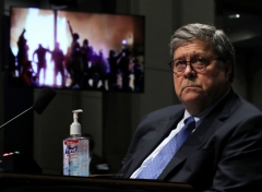 Attorney General William Barr watches a Republican Exhibit video of people rioting, during the House Judiciary Committee hearing in the Congressional Auditorium at the US Capitol Visitors Center July 28, 2020 in Washington, DC. (Photo by CHIP SOMODEVILLA/POOL/AFP via Getty Images)