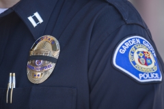 Featured is a policeman uniform and badge. (Photo credit: APU GOMES/AFP via Getty Images)