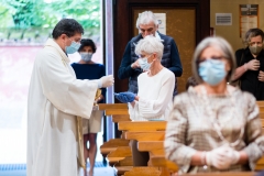 A priest administers communion at church. (Photo credit: Marco Mantovani/Getty Images)