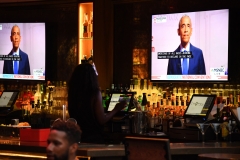 Former U.S. President Barack Obama is seen on television screens as he speaks during the third day of the Democratic National Convention, being held virtually amid the novel coronavirus pandemic, at The Abbey bar and restaurant in West Hollywood, Calif. (Photo credit: ROBYN BECK/AFP via Getty Images)
