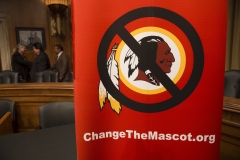 A poster for the "Change the Mascot" campaign is seen prior to a press conference by the Oneida Indian Nation leaders on Capitol Hill in Washington, D.C., September 16, 2014. (Photo credit: SAUL LOEB/AFP via Getty Images)