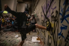 Protesters kick the door of the defaced U.S. Courthouse in Portland, Oregon, on July 20, 2020. (Photo by Paula Bronstein/Getty Images)