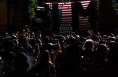 Protesters raise their fists during BLM protests in Portland, Oregon. (Photo by Alisha Jucevic/AFP via Getty Images)