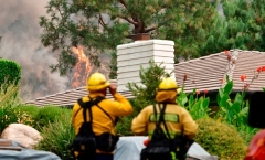  Fire burns on a hillside behind homes in Arcadia, California on September 13, 2020. (Photo by FREDERIC J. BROWN/AFP via Getty Images)