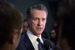 California Gov. Gavin Newsom speaks to the press in the spin room after the sixth Democratic primary debate. (Photo credit: AGUSTIN PAULLIER/AFP via Getty Images)