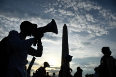 Protesters march near the Washington Monument. (Photo credit: BRENDAN SMIALOWSKI/AFP via Getty Images)