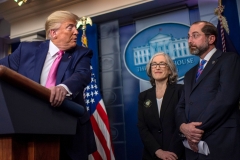 President Donald Trump turns to address Secretary of Health Alex Azar as he speaks during a news conference on the COVID-19 outbreak at the White House. (Photo credit: ERIC BARADAT/AFP via Getty Images)