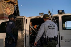 Migrants, mostly from Central America, board a van which will take them to a processing center, on May 16, 2019, in El Paso, Tex. (Photo credit: PAUL RATJE/AFP via Getty Images)