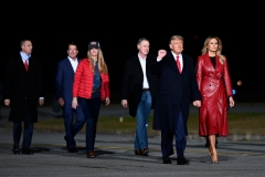 US president Donald Trump (2nd R) holds up his fist as he arrives with First Lady Melania Trump (R) and Georgia Republican Senators David Perdue (C) and Kelly Loeffler for a rally to support Republican Senate candidates at Valdosta Regional Airport in Valdosta, Georgia on December 5, 2020. (Photo by ANDREW CABALLERO-REYNOLDS/AFP via Getty Images)