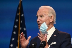 President-elect Joe Biden waves a face mask as he answers questions about COVID 19 in Wilmington, Delaware on November 16, 2020. (Photo by ROBERTO SCHMIDT/AFP via Getty Images)