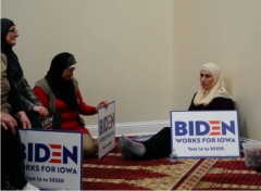 Participants hold Biden campaign sings at the Iowa caucus at the Islamic Education Center Ezan mosque in Des Moines, Iowa, Feb. 3, 2020. (Photo by Elijah Nouvelage/Bloomberg via Getty Images)