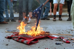 This 20 April 2002 file photo shows demonstrators burning U.S. flags in front of the World Bank headquarters during a protest against the International Monetary Fund - World Bank spring meetings in Washington, D.C. (Photo credit: HIROKO MASUIKE/AFP via Getty Images)