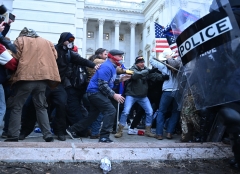 Trump supporters clash with police and security forces, as they storm the U.S. Capitol in Washington, D.C., on Jan. 6, 2021. (Photo credit: BRENDAN SMIALOWSKI/AFP via Getty Images)