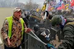 A Trump supporter screams at police and security forces as demonstrators storm the US Capitol on January 6, 2021. (Photo by JOSEPH PREZIOSO/AFP via Getty Images)