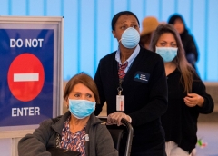 Passengers wear face masks to protect against the COVID-19 (Coronavirus) after arriving at the LAX airport in Los Angeles, California on March 5, 2020. - California has declared a state of emergency as the number of novel coronavirus cases and deaths in the US continues to climb. (Photo by MARK RALSTON/AFP via Getty Images)