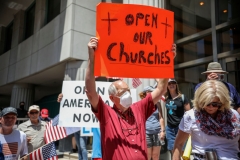 Demonstrators holding signs demanding their church to reopen, protest during a rally to re-open California and against Stay-At-Home directives on May 1, 2020 in San Diego, California. - Rallies have been held at several state capitols across the country as protesters express their deep frustration with the stay-at-home orders that are meant to stem the spread of the novel coronavirus. (Photo by SANDY HUFFAKER/AFP via Getty Images)