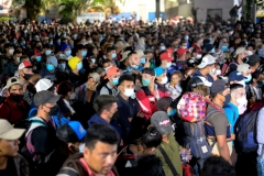 Thousands of Honduran migrants push through the police fence as they attempt to cross the border at El Florido in Guatemala forming the first migrant caravan of the year on it's way to the United States on January 15, 2021. (Photo by JOHAN ORDONEZ/AFP via Getty Images)